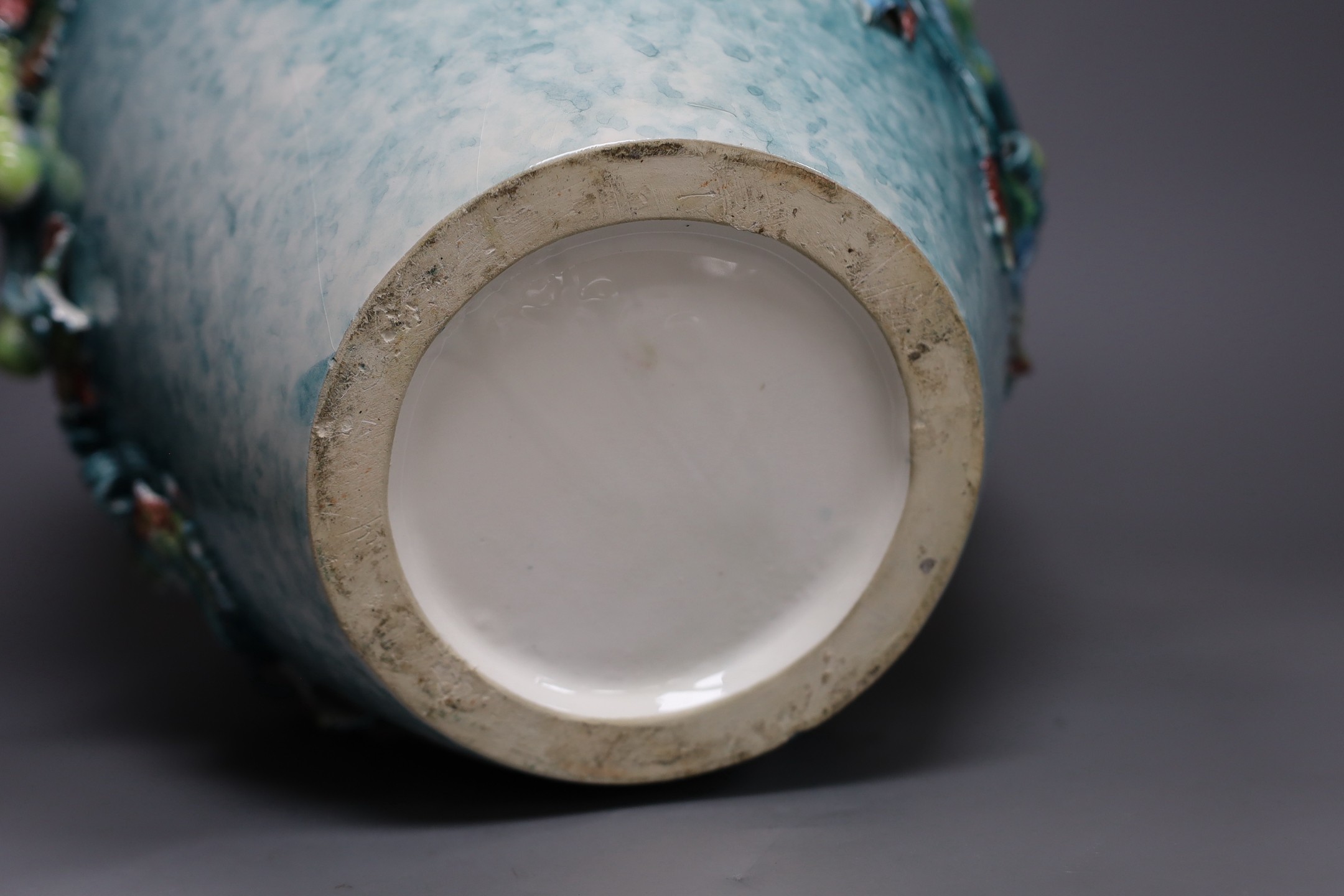 A large late 19th/early 20th century Continental polychrome glazed ‘grape vine’ vase, 39cm tall